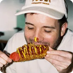 Chef eating a slice topped with butter